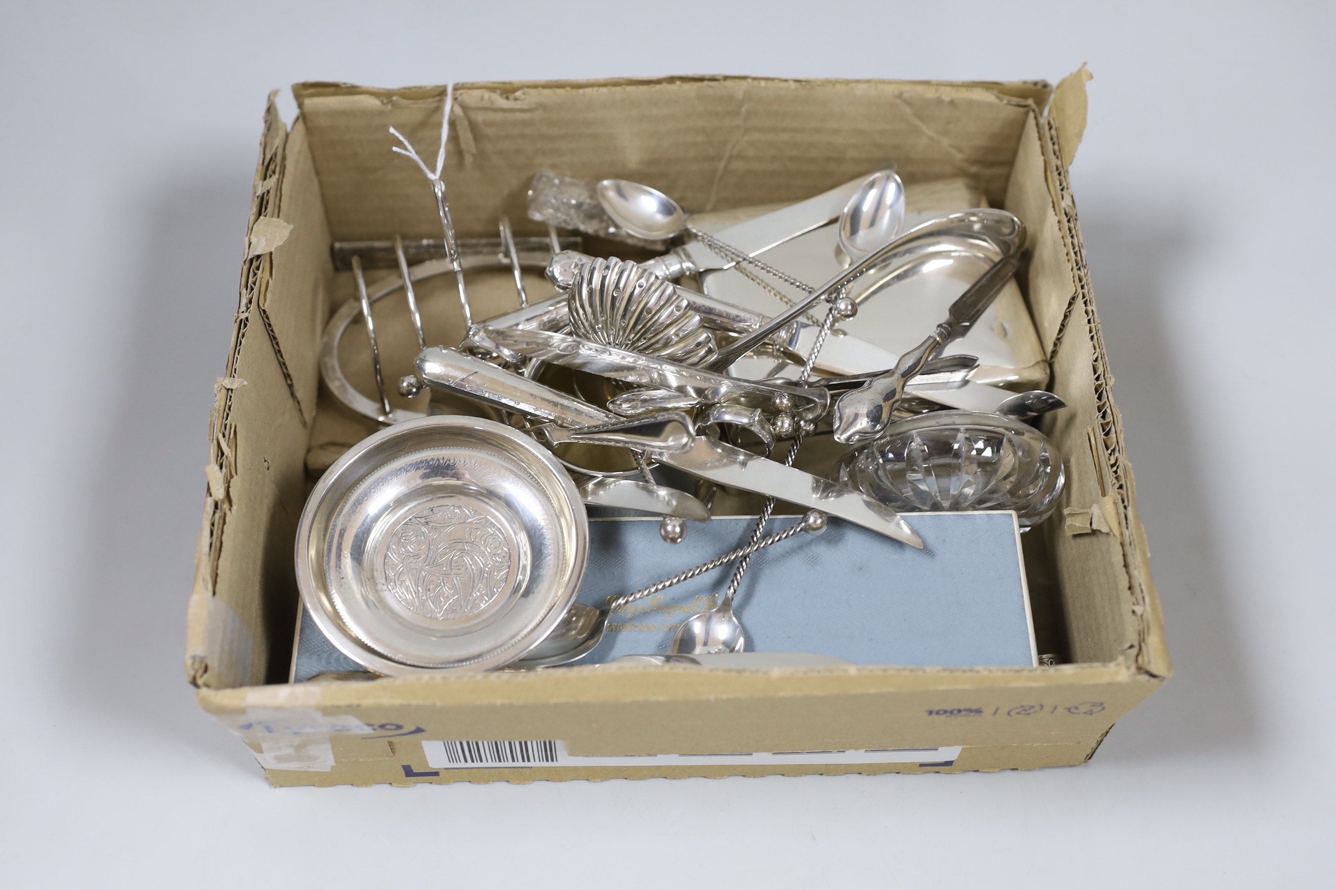 A small group of sundry small silver including a set of four napkin rings, cigarette box, sugar bowl, toastrack, scent bottle, 19th century white metal needle case, Egyptian white metal dishes and assorted flatware inclu